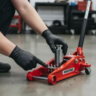 Close-up of a mechanic inspecting a Daytona 3 Ton Low Profile Floor Jack during maintenance