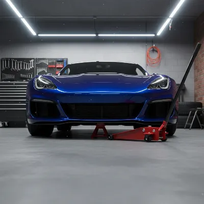 A sleek, red low profile floor jack positioned under a sports car in a clean garage.